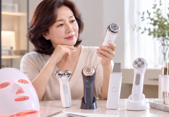 50대 여성이 여러 종류의 홈 뷰티기기를 비교해 고르는 모습